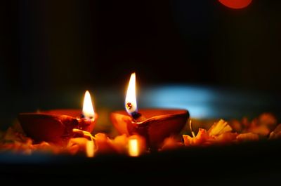 Close-up of lit candles in the dark