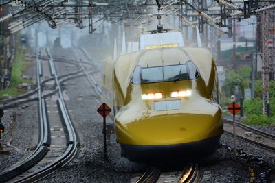 Series 923 shinkansen doctor yellow passing through maibara station in the rain