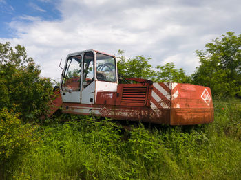 Abandoned truck on field against sky