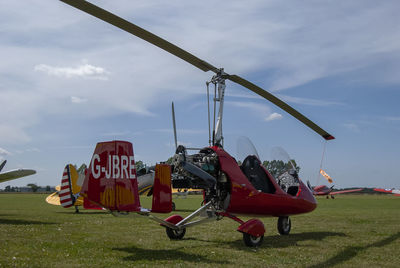 Traditional windmill on field against sky