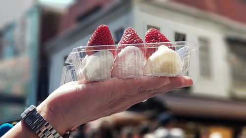 Close-up of hand holding ice cream