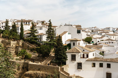 Houses in town against sky