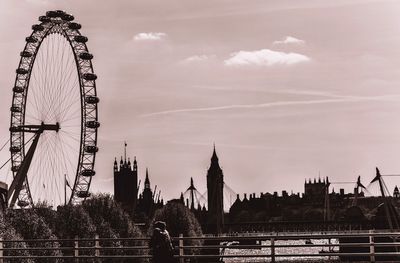 Ferris wheel in city against sky