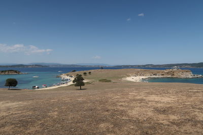 Scenic view of beach against blue sky