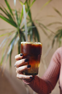 Cropped hand of woman holding drink