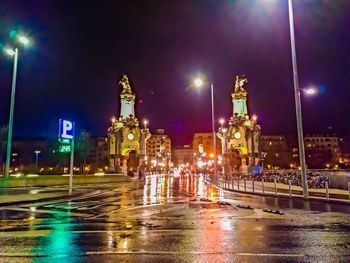 Illuminated city street at night