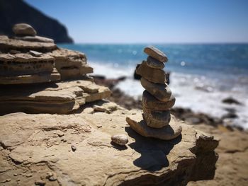 Stacked stones on rock at beach