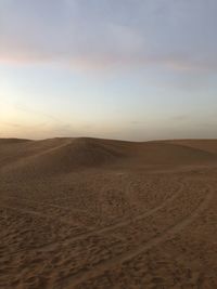 Scenic view of desert against sky during sunset