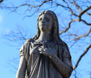 Low angle view of statue against blue sky