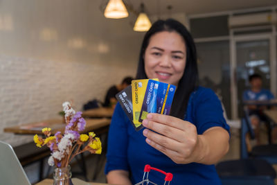 Portrait of a smiling young woman holding food