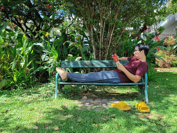 Side view of woman sitting on field