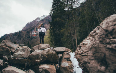 Man standing on rocks against mountain