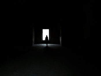 Full length of woman walking in tunnel