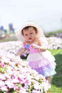 Portrait of cute girl with pink flowers