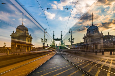 Railroad tracks amidst buildings against sky