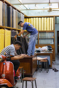 Rear view of children sitting on table