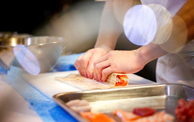 Midsection of man preparing food in kitchen