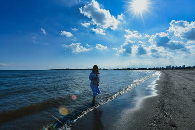 Full length of man on beach against sky