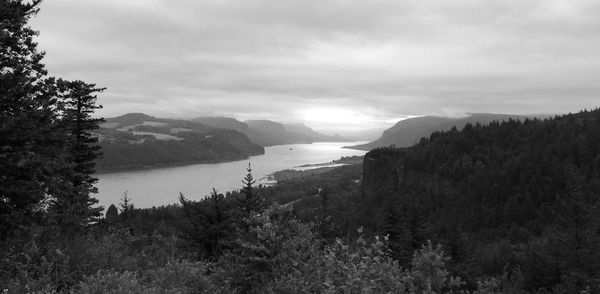 Scenic view of mountains against cloudy sky