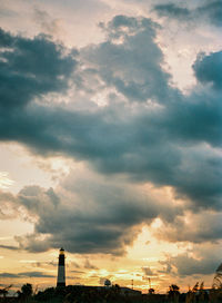 Low angle view of silhouette built structure against sky