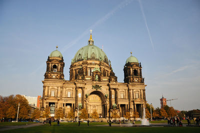 Low angle view of berlin cathedral against sky under sunset lighting