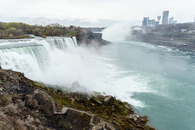 Scenic view of waterfall against sky