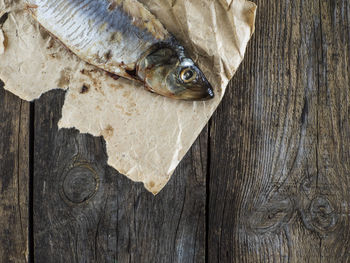 Close-up of herring on paper at table