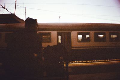 Rear view of silhouette woman against sky