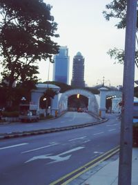 Road by city against sky