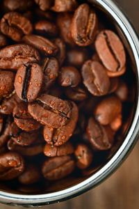 Closeup roasted coffee beans in coffee machine filter