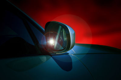 Reflection of illuminated car on mirror