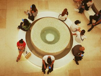 High angle view of people sitting on floor