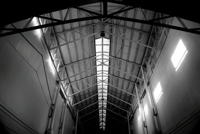 Low angle view of illuminated lights hanging on ceiling in building