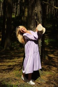 Rear view of woman standing in forest