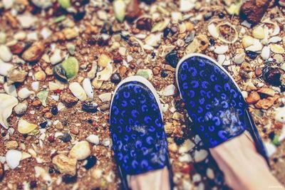 Low section of person legs on pebbles