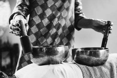 Woman playing tibetan singing bowl in sound healing therapy