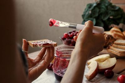 Midsection of woman holding food on table