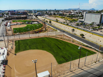High angle view of soccer field and buildings against sky