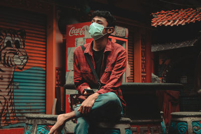 Full length of man sitting on seat