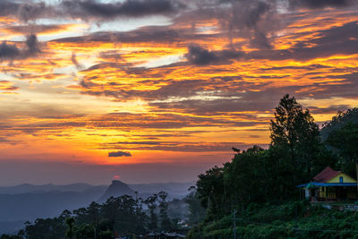 Scenic view of mountains against orange sky