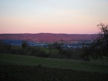 Scenic view of field against sky during sunset