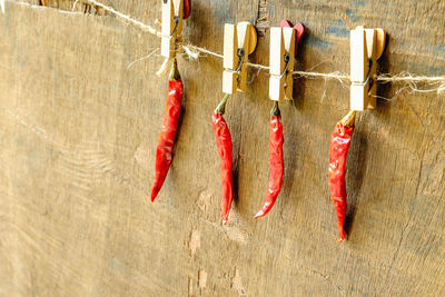 Close-up of red chili peppers against wall