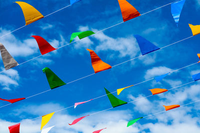 Low angle view of flags against sky