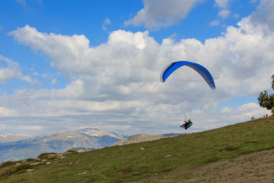 Paragliding flying through the green meadows.sport concept