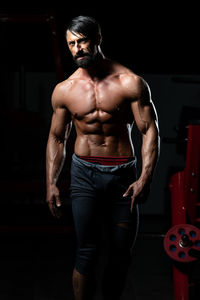 Shirtless man standing in gym