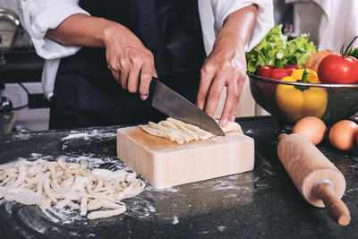 Midsection of man preparing food in kitchen