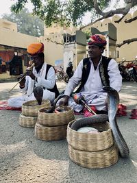 People sitting in basket on street