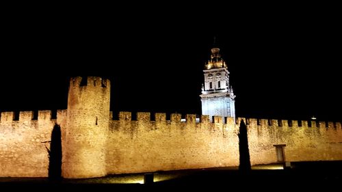 Low angle view of illuminated building against sky at night