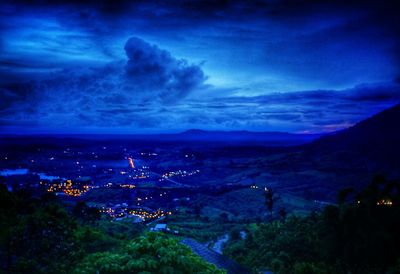 High angle view of illuminated city against sky at dusk