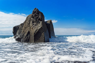 Rock formation on praia formosa beach in portuguese island of madeira